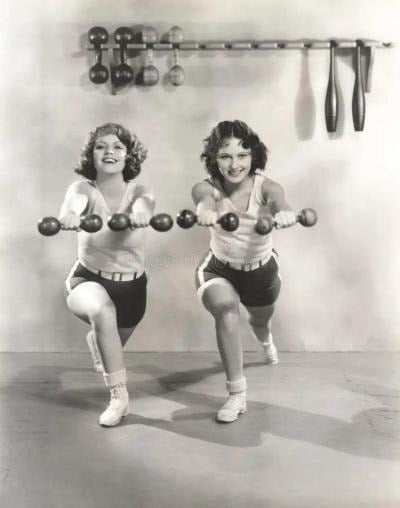 Two women lunging with dumbbells held out in front of them, in black and white