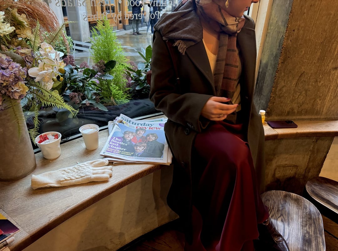 A woman reading by a café window